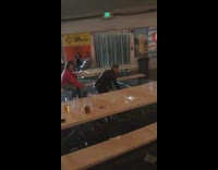 Guy knocks over cup pyramid 