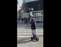 Man ride hoverboard smoke cigar selfie stick