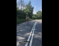 Man walks in park with thong and hat