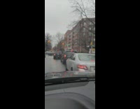 Grey car windshield wiper up and swinging