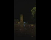 Guy walking in rain lighting lights up sky 