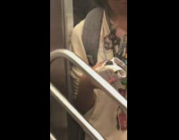 Girl rainbow lanyard holds bird in white rag in her hand on the subway 