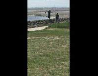 Girl black hat spread arms stand rocks