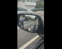Girl lay on pavement legs over car
