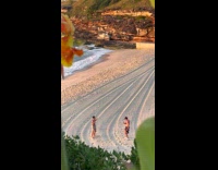 Collab IITW - Man shirtless flexes muscle at beach sunset