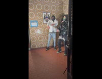 Guys wearing balaclava and bandanas recording music video