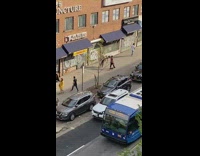 Man holding life size human doll on street