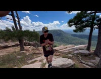 Guys plays catch with pinecone in wind