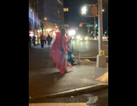 Woman pink wings pose on street night