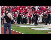 Glen Powell shooting Chad Powers at Sanford Stadium