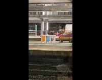 Two men in mask dances at station