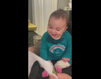 Dad makes baby laugh by tearing apart a piece of paper