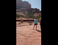 Woman red pants hold leg yoga pose 