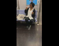 A woman brushes teeth with green brush