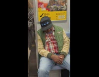 Man in Cap with LED Text Sleeps 