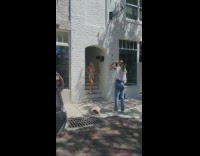 Woman in brown dress poses at the door archway