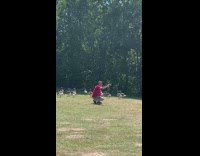 Man sunglasses red shirt crouch selfie ducks 