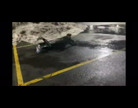 Guy rides saucer sled down snow pile 