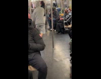 Man holds flashlight circles inside the train