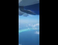 Plane ride view flies over Maldives scenery 