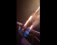 Guy holds and shoots firework cannon arms
