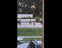 Shirtless man back flip beverly hills sign