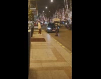 Man white jacket plant lights street night