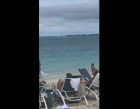 Guy does cobra  yoga pose on beach and takes picture