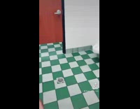 Guy in bathroom taking selfie while person uses toilet 