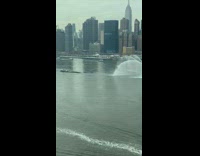 Boat making a tribute by streams of colored water