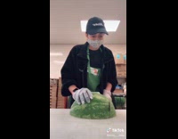 Girl cuts watermelon into slices