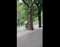 Two guys rides tall bike at park