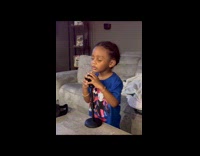 Little boy with microphone feels the song