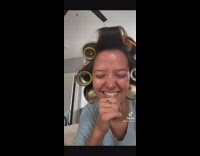 Cat touching womans hair curl rolls 