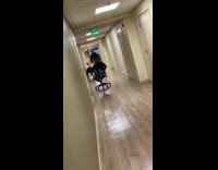 Collab Kale Salad IG - Guy rolls on chair down hallway