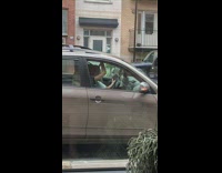 Two girls sit dance parked SUV car