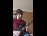 Man in red shirt performs guitar solo