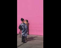 Teen guy dye shirt tiptoe pink wall