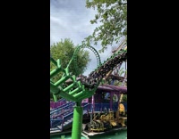 People rides the rollercoaster at the amusement park in slow motion