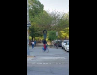 Cyclist balance tire and trash can on head
