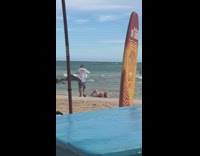 Blonde woman pink bikini lay beach surfboard