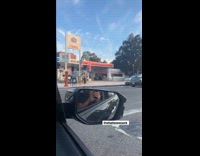 Person stands with american flag pole on back 