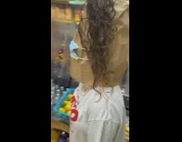 Lady wears mask and paper bag 