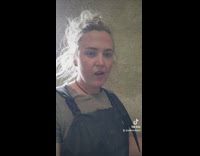 Lady Looks and Imitates Cow as it Chews