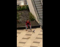 Guy striped sleeves sit garden between escalators