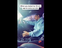 Guy in manual car waits for girlfriend 