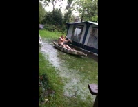 Guy brown canoe boat grass rain puddle 