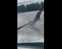 Four guys hold black bar barefoot boat