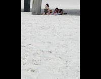 Woman onesie butt shot under bridge beach