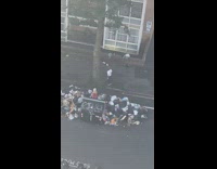 Woman in red dress poses at the garbage pile